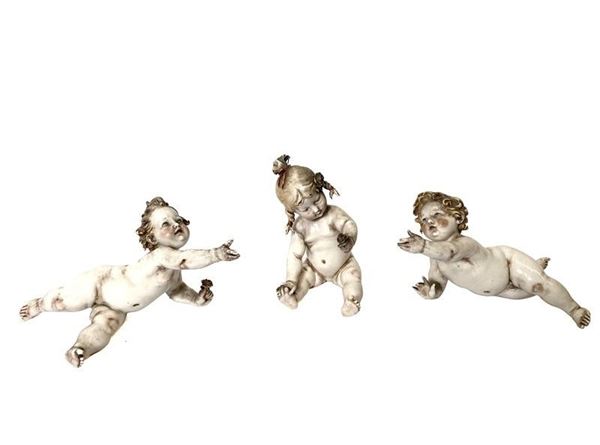 Little girl with flower and two cherubs